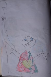 Dessin de Maëlle: c'est maman qui décroche les graines d'annatto de l'arbre.